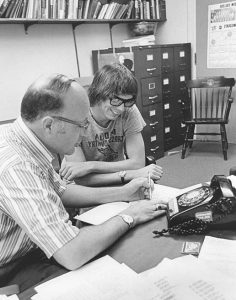 Counseling Will Terry style, a man sitting with a student and a cord telephone in front of them