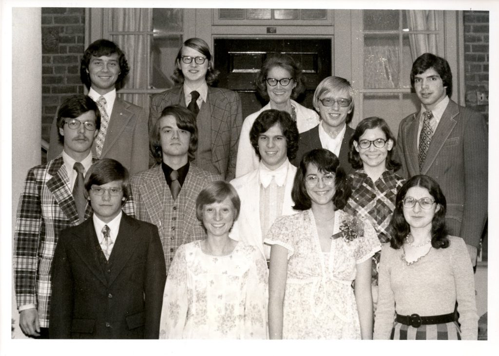 Members of the 1976 debate team pose together for the picture. Back row, left to right: Steve Smith, Mark Gergen, Coach Jean Cornell, Robert Enright, and Mike Daisley; middle row: Unknown, Gordon Widenhouse, unknown, unknown; front row: Randy Sherrill, Ellen Ogilvie, Nancy Northcott, and Maria Patterson.