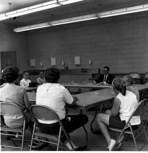 Alumni Weekend, June, 1963, Dr. William Hight, Director of Student Counseling sitting at the head of four tables formed into a sqaure talking to parents and their children