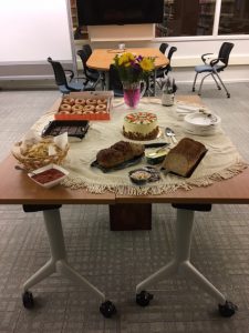 Research, Teaching, and Collection department's contributions to welcome Jessica Cottle. Table full of donuts, cake, bread, and paper plates