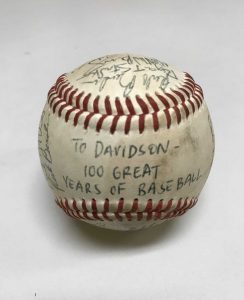 A baseball with "To Davidson - 100 Great Years of Baseball" and signatures of past players on it.