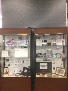 Glass exhibit cases filled with artifacts and articles about AIDS at Davidson