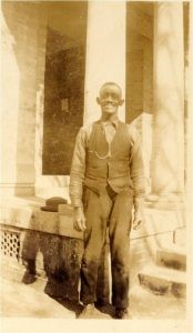 A photo of Enoch Donaldson standing in front of a building.

