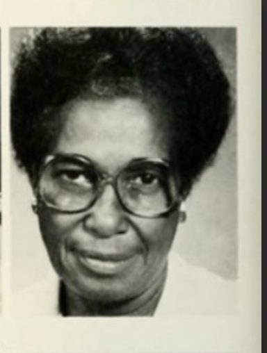 Black and white headshot image of Fannie Brandon. Fannie is wearing large glasses, has short hair and is wearing a white collared shirt. 