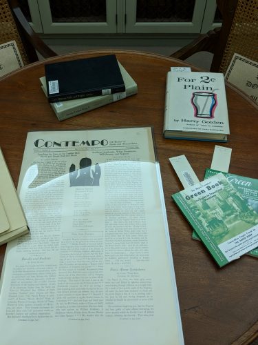 Green Books, Contempo magazine, For 2 Cents Plain, and MLK publications arranged on a table for a Humanities course.