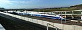 Rames de TGV Euroduplex (2N2) numéro 4703 et de TGV Duplex Dasye numéro 746 stationnées en gare de Belfort - Montbéliard TGV. Au loin la commune de Moval